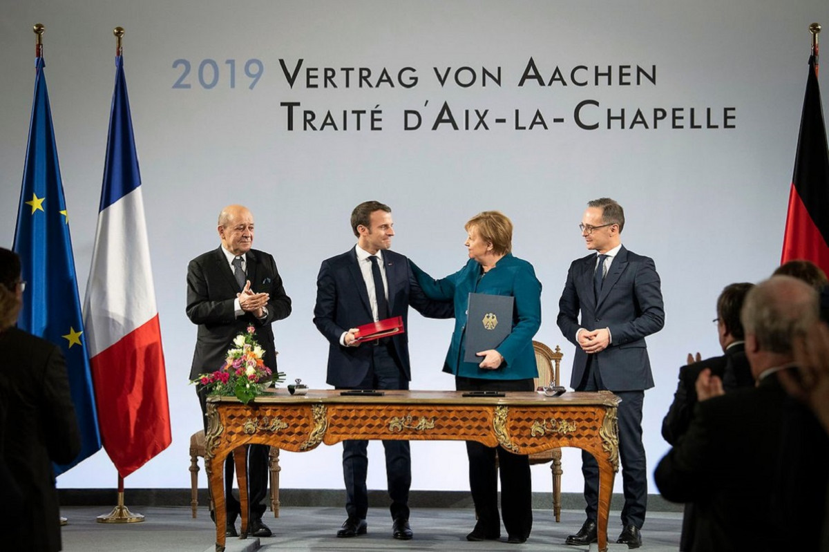 Photo shows French President Emmanuel Macron and German Chancellor Angela Merkel signing the new friendship treaty in the German city of Aachen. Photo: Bundesregierung/Bergmann 2019.