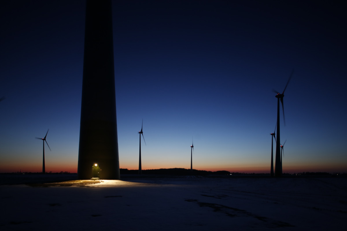 Wind turbines in Germany set against a darkening sky. 