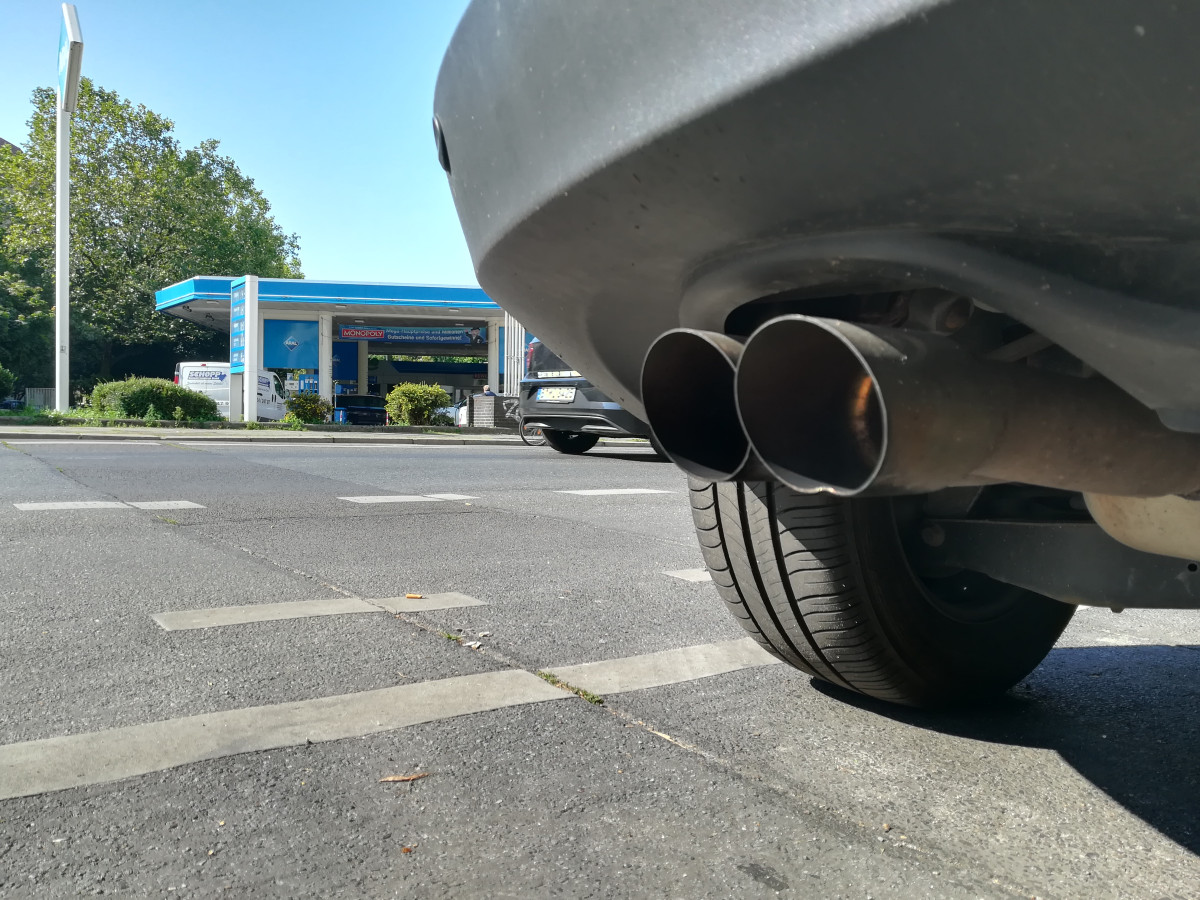 Car exhaust in front of gas station