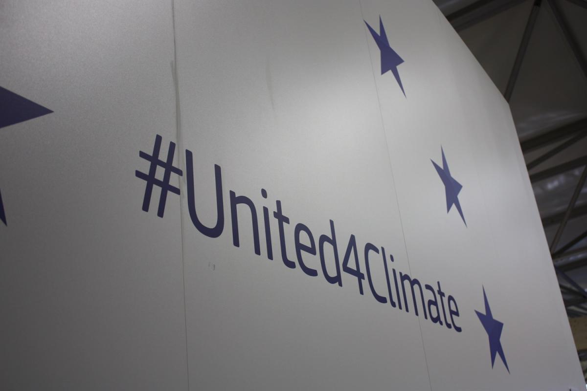 A sign reading "#United4Climate". Source - CLEW 2017.