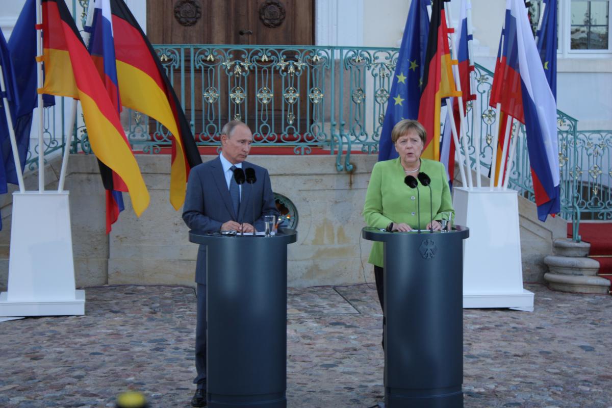 Russian President Vladimir Putin and German Chancellor Angela Merkel ahead of their work meeting at the German government's guest house in Meseberg. Source - Julian Wettengel CLEW.