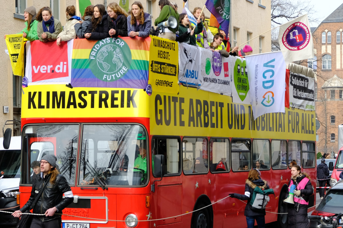 Photo shows protesters in red bus for climate strike in March 2024.  Photo: VCD / Jan Langehein.