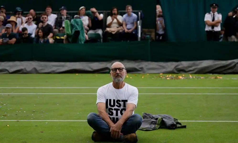 A "Just Stop Oil" activist during a protest at the Wimbledon tennis tournament. Image by Just Stop Oil