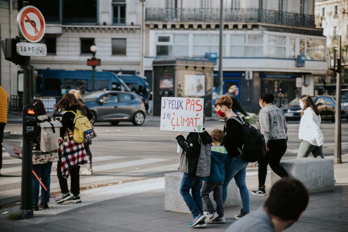 Photo shows climate protesters in Paris, France. Photo by Mat Napo on Unsplash. 